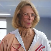 Older woman with blonde hair and glasses
